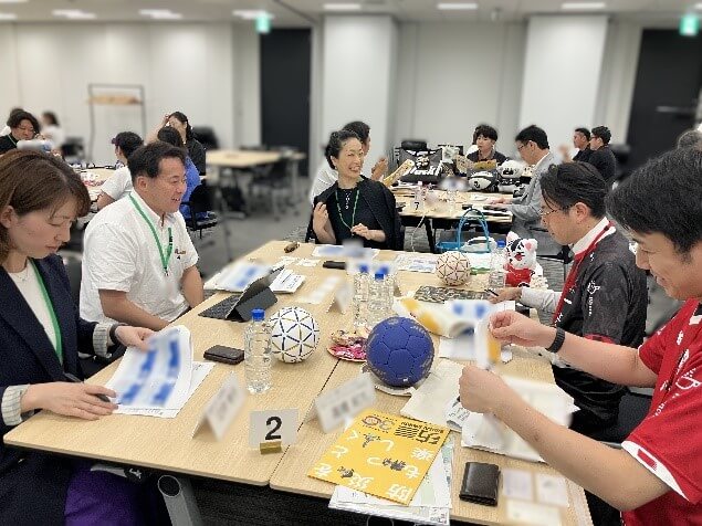 参加者が5人でテーブルを囲み話している様子